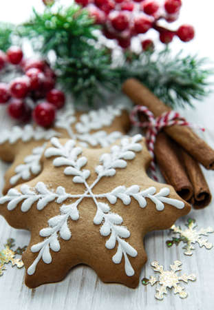 Christmas gingerbread with christmas decorations on white woodenの写真素材