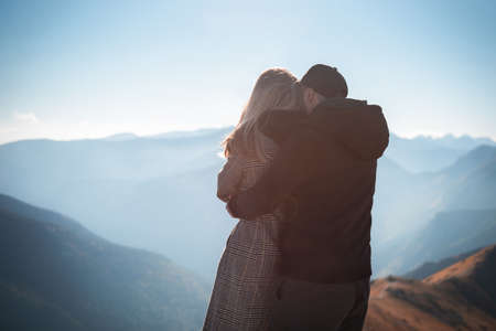 Young happy couple having a break during a hiking trip in the mountainsの写真素材