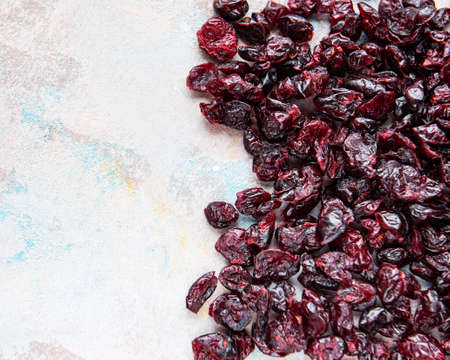 Sweet dried cherries on gray concrete background