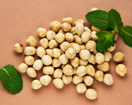 Peeled hazelnuts on a brown paper backgroundの写真素材