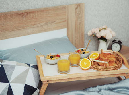Romantic breakfast with coffee, waffles, orange juice and rose flowers.の写真素材