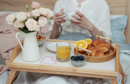 Romantic breakfast with coffee, waffles, orange juice and rose flowers.の写真素材