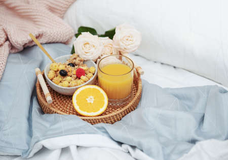 Romantic breakfast with orange juice and rose flowers.の写真素材