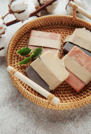 Assorted handmade natural soap bars, massage towel and green leaves. Spa and massage concept. Healthy lifestyleの写真素材