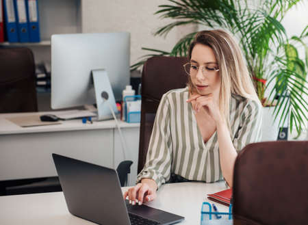Young woman working on a computer in her office