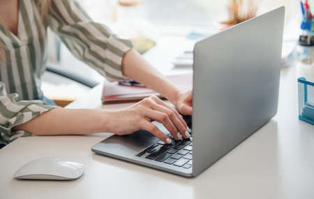 Young woman working on a computer in her office