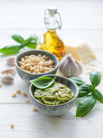 Fresh made Pesto sauce. Green basil pesto.  Ingredient for pesto sauce - Fresh Basil, Pine Nuts, Olive Oil and Cheeseの写真素材