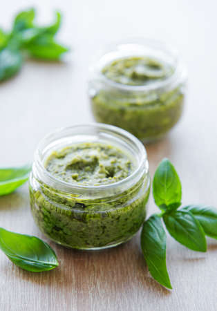 Fresh made Pesto sauce. Green basil pesto.  Ingredient for pesto sauce - Fresh Basil, Pine Nuts,...