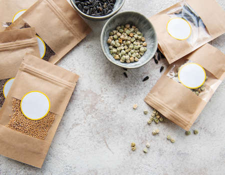 Microgreen seeds in paper bags and microgreen sowing equipment on the table. Healthy food.