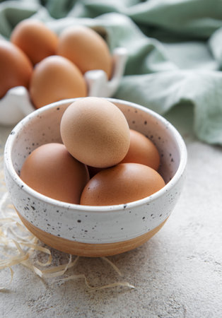Bowl of fresh  brown eggs on concrete backgroundの写真素材