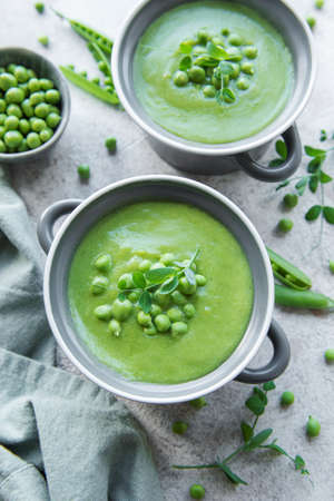 Fresh green pea soup bowl on gray concrete backgroundの写真素材