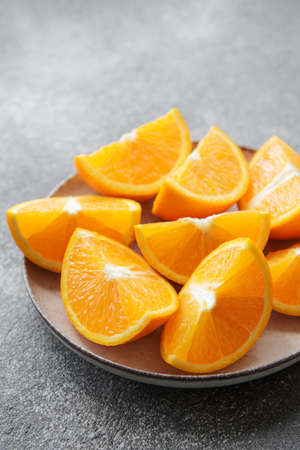Fresh ripe oranges on dark concrete background