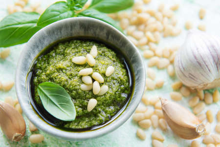 Fresh made Pesto sauce. Green basil pesto.  Ingredient for pesto sauce - Fresh Basil, Pine Nuts, Olive Oil and Cheeseの写真素材