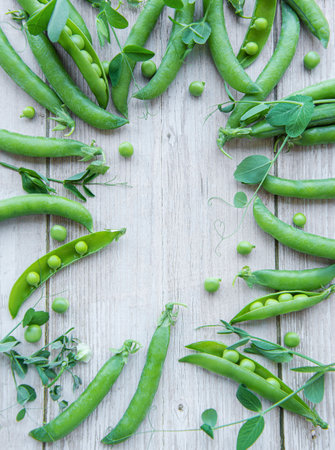 Green peas with leaves on a wooden backgroundの写真素材