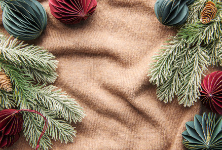Handmade eco paper ball, closeup view. Christmas holiday decorations on a brown knitted background.の写真素材