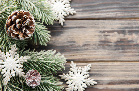 Christmas background with fir tree and decor on old wooden background background. Top view with copy spaceの写真素材
