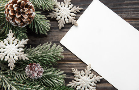 Christmas background with fir tree and decor on old wooden background background. Top view with copy spaceの写真素材
