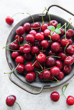 Fresh red cherries fruit  on a concrete background