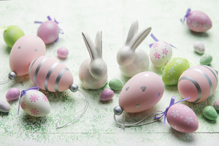 Decorative rabbits and  Easter eggs on the table. The concept of Easter holidays.