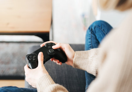 A  girl holding game controller playing video games