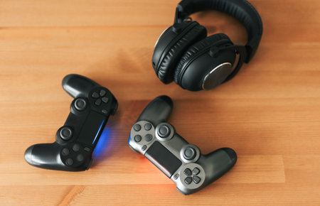 Video gaming consoles. Top view a gaming gear  on the table background. Joystick or gamepad on a table.の写真素材