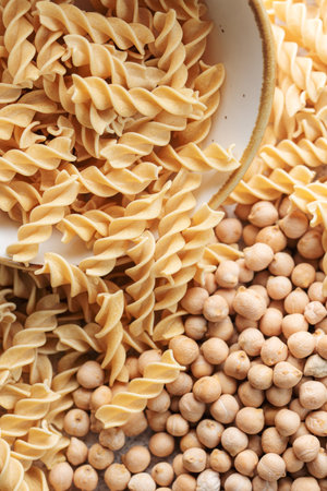 Chickpea bean fusilli pasta. Bowl with raw pasta and chickpea bean. Gluten free pasta.の写真素材
