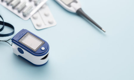 Medical kit for the prevention and treatment of coronavirus. Mask, test, pulse oximeter and medication on a blue background.の写真素材