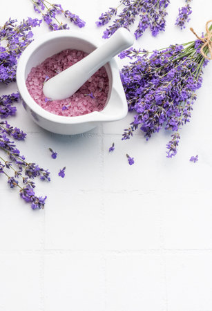 Lavender spa. Lavender salt and fresh lavender on a white tile background.の写真素材