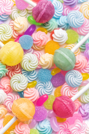 Colorful sweet lollipops and candies over white background.  Flat lay, top viewの写真素材