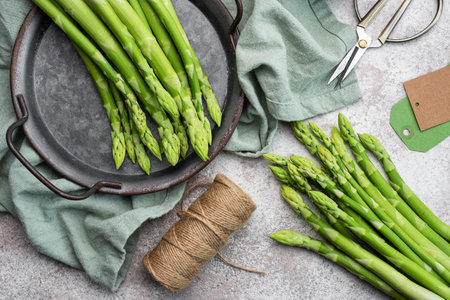 Fresh green asparagus on grey concrete background. Flat layの写真素材