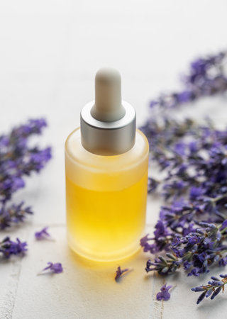 Lavender spa. Lavender  natural essential oil and fresh lavender on a white tile background.の写真素材