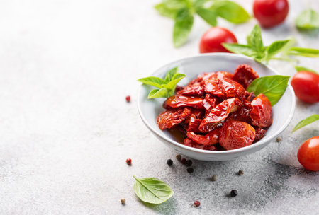 Bowl with homemade sun dried tomatoes with fresh herbs and spices.の写真素材