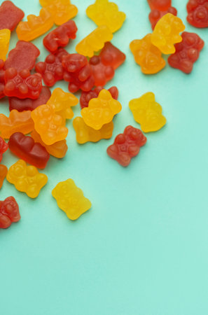 Vitamins for children,   jelly gummy bears candy on pastel green  background