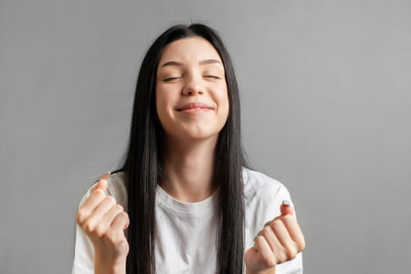 Portrait of a young teenager girl who rejoices in success.の写真素材