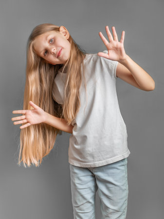 Portrait of cute little girl with long light hair  in white t-shirtの写真素材