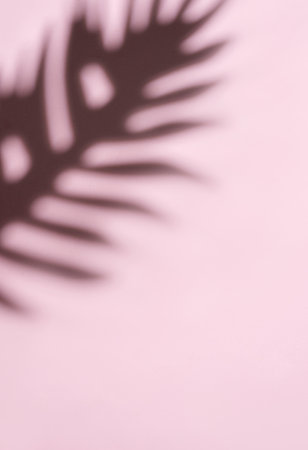 This image captures a dreamy, abstract pattern formed by the blurred movement of palm fronds in a...
