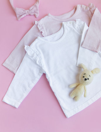 Set of baby bodysuits, pants, socks and knitted toy. Fashion baby clothes and accessories. Flat lay, top viewの写真素材