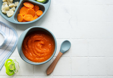 Healthy baby food in bowl.  Baby food vegetable puree with carrotの写真素材