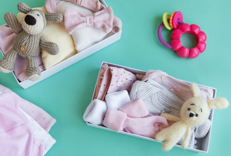 Baby and child clothes and knitted toys in carton box.  Donation, charity concept.