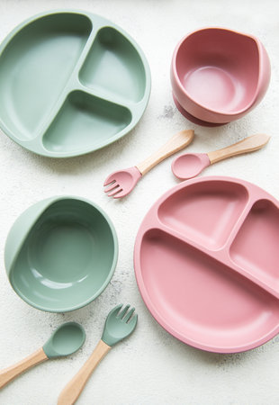 Collection of reusable colorful plastic dishes and bowls for baby foodの写真素材