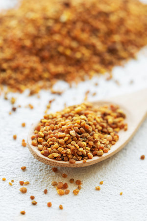Healthy bee pollen grains.  Bee pollen on a wooden spoonの写真素材