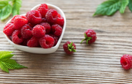 Fresh organic ripe raspberry with leavesの写真素材