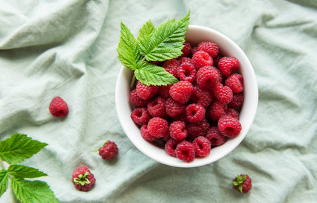 Fresh organic ripe raspberry with leavesの写真素材