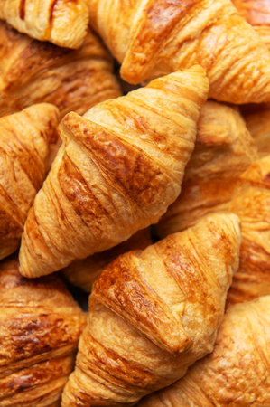Delicious golden brown croissants stacked together, creating a tempting image for breakfast or brunchの写真素材