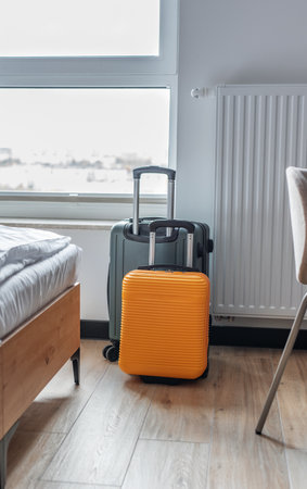 Luggage and travel bags in a hotel bedroom symbolize vacation and journeyの写真素材