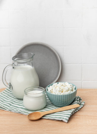 Jug of milk, yogurt, and cottage cheese in a bowl for a healthy breakfast