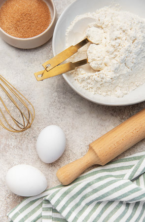 Flour, eggs, sugar, and baking tools creating a cooking scene