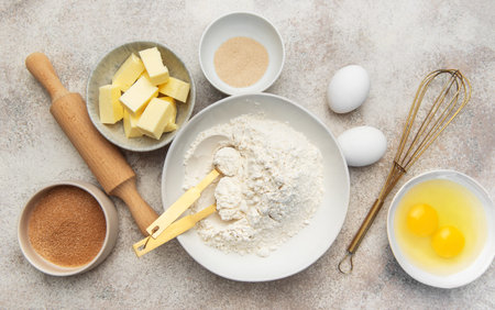 Baking ingredients arranged on a textured surface, ready for homemade dough preparation