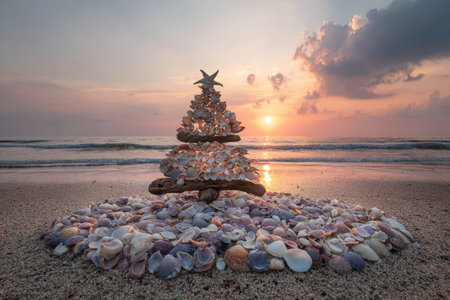 Unique alternative Christmas tree crafted from seashells on sandy beach, illuminated by sunset, showcasing natural textures and a serene coastal ambianceの素材