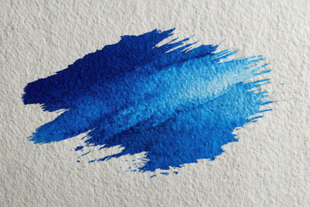 Blue watercolor brush stroke on textured paper, displaying rich colors and artistic details, ideal for backgrounds or creative designs with copy spaceの素材